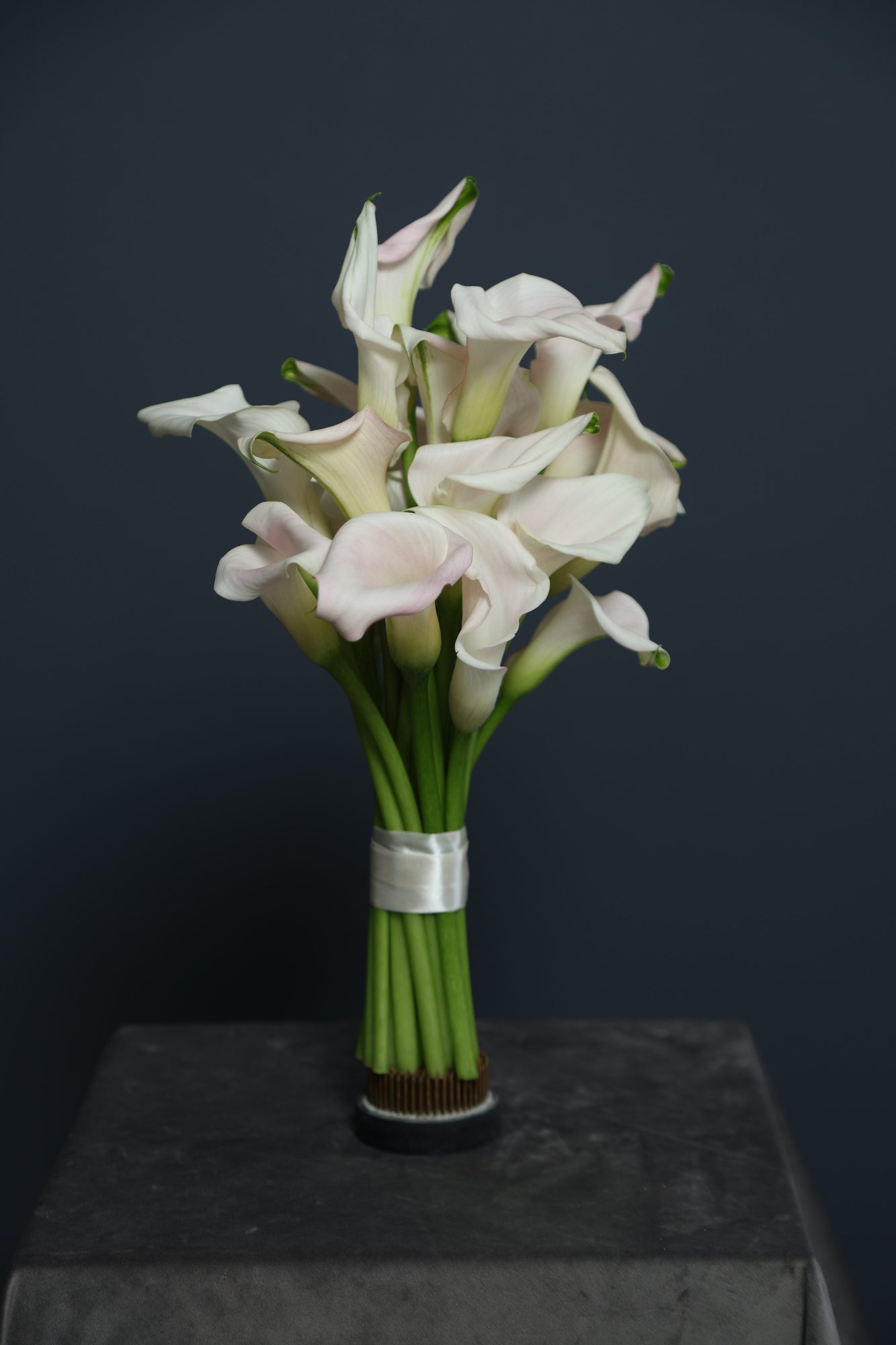 Calla Veil bridal bouquet with soft pink calla lilies and ribbon-wrapped stems