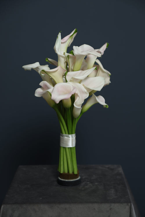 Calla Veil bridal bouquet with soft pink calla lilies and ribbon-wrapped stems