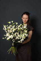 Pearl Cloud white snowberry and freesia bouquet with a loose natural shape