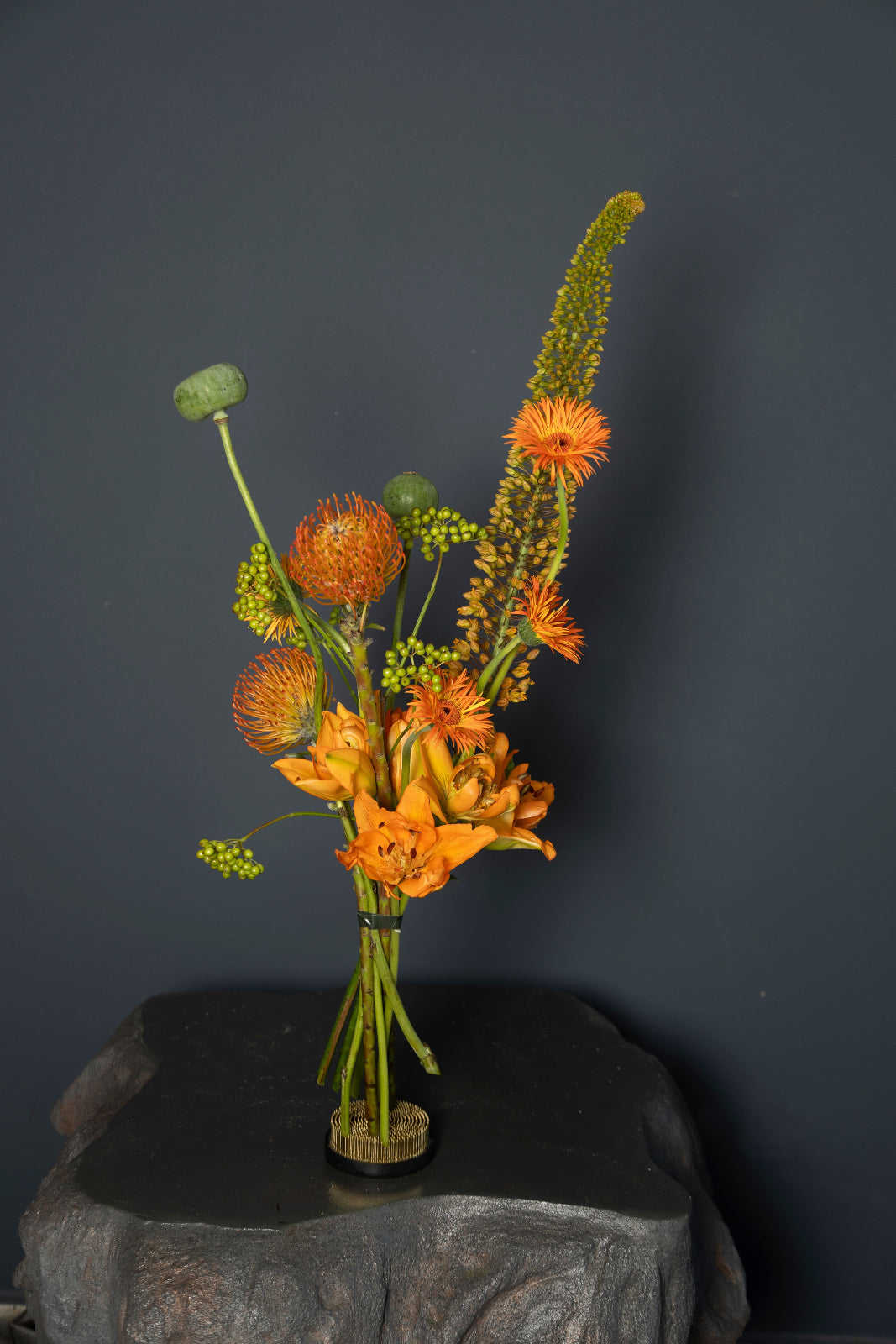 Phoenix orange designer bouquet with gerberas, alstroemeria, green berries, and decorative pods