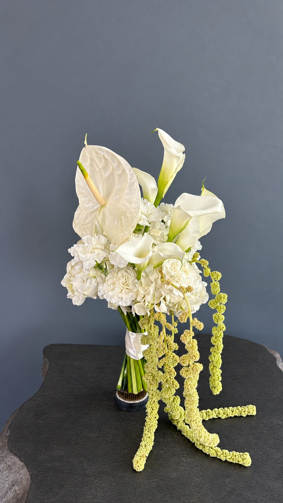 Silk & Ivory asymmetrical bridal bouquet with white flowers and pale green cascading amaranthus