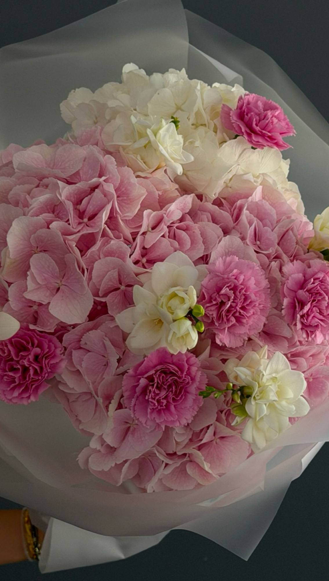 Close-up of Soft Romance bouquet with pink hydrangeas, carnations, freesias, and cream flowers