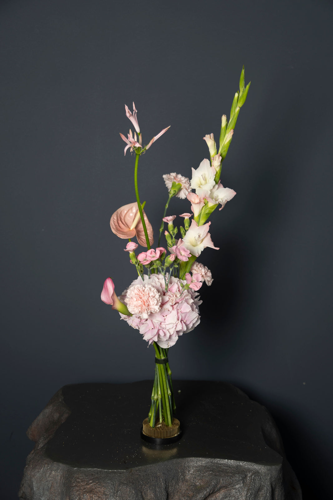 The Pink designer bouquet with gladiolus, carnations, calla lily, anthurium, and soft pastel flowers